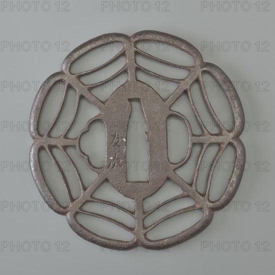Crossguard tsuba, Tomotsugu, Japanese art, Japanese culture, Edo 1603–1868, swords, weapons, melee weapons, katana, sword crossguards, openwork, Tsuba sukashi in the shape of a seven-petaled mokkô rosette, with openwork petals divided by arched lines forming a spiderweb pattern, with integrally woven ryôhitsu ana holes and an oval seppa dai. Signed. 19th century, Edo period 1603–1868, Japan, tsuba, height 8.0 cm, width 7.8 cm, depth 0.6 cm, A round metal object with an openwork floral or petal-like pattern, showing a central elongated oval opening flanked by a rectangular cutout and a scalloped shape, all surrounded by a ring of curved, connected petal shapes; the metal surface appears dark brown to rusty with areas of lighter brown and gray patina, and the background is a smooth pale gray.