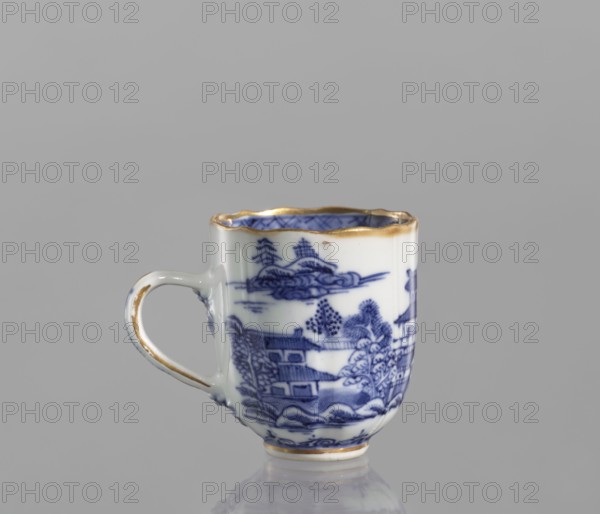 Cup, ceramics, blue-and-white porcelain, Qing style, landscape motifs, Chinese art, Qing dynasty 1644–1911, part of a 22-piece tea and coffee set including a teapot, 6 cups, 6 saucers, a bowl, a cover and a plate, 19th century Qing dynasty, 1644–1912, China, vessel; height 6.5 cm, width 5.9 cm, diameter 5.9 cm., A small ceramic cup with a handle sits against a plain gray background, decorated with blue painted landscape scenes and foliage on a white base; the rim and parts of the handle and base are accented in gold, and the cup shows a scalloped top edge and a glossy finish reflecting light.