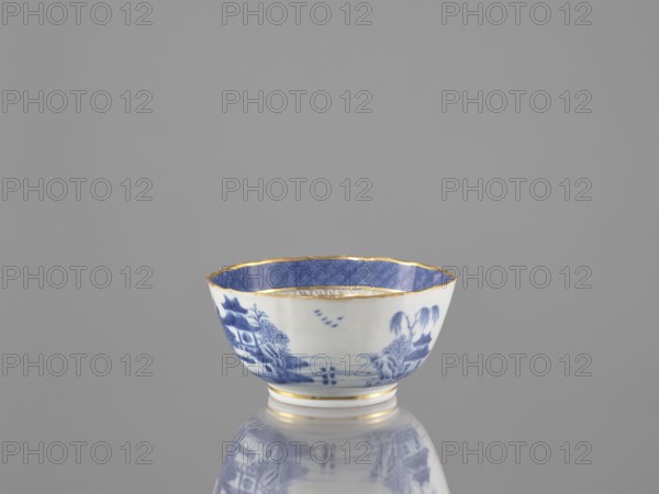 Teapot, ceramics, blue-and-white porcelain, Qing dynasty, 19th century Qing dynasty, 1644–1912, Chinese, landscape motifs, part of a 22-piece tea and coffee service including teapot, 6 cups, 6 goblets, 6 saucers, a bowl, a cover, and a plate; vessel, height 7 cm, diameter 14.3 cm, A small porcelain bowl sits centered against a plain grey background, showing a white exterior with blue painted landscape motifs and a blue patterned interior rim, both edged with a thin gold trim; the bowl rests on a short foot and casts a subtle reflection on the glossy surface beneath it, and visible colors include white, blue, gold, and grey.