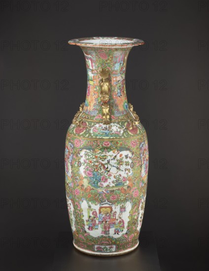 Vase, Chinese, 19th century, China. Porcelain vessel height 93.0 cm, diameter 34.0 cm with colored glaze, decorative figural court scenes, butterflies, plant and floral ornaments; decorative vase for display. Provenance unknown., A tall decorative vase with a flared rim displayed against a dark background; the vase is covered in a dense, ornate pattern featuring a dominant palette of green, pink, red, gold, blue, and white, with additional accents of orange and black; the neck and body include several framed panels showing small scenes with human figures and floral motifs, surrounded by intricate scrolling foliage and stylized geometric borders; there are metallic gold-colored sculpted handles and applied ornamental elements on the shoulder and neck; the central body panels contain depictions of birds among flowers and separate panels showing groups of people in interior or courtyard settings; the rim edge and base have decorative bands that repeat the colorful floral and geometric des...