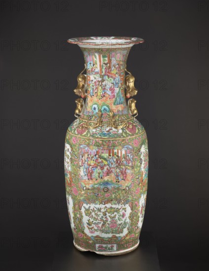 Vase, Chinese, 19th century China. Colored porcelain vessel with figurative court scenes, butterflies, floral and plant ornament decoration. Height 93 cm; diameter 34 cm., A tall decorative vase with an elongated neck and flared rim stands against a dark background, covered in dense painted scenes and patterns in green, pink, red, gold, blue, white, and touches of brown and black; the neck and body display detailed figural panels showing groups of people in colorful robes set within architectural and garden elements, surrounded by ornate floral and foliate borders in green and pink with gold accents; the shoulders of the vase feature sculpted gold-colored mask-like handles projecting from either side; lower sections include framed cartouche areas with floral and bird motifs on white backgrounds, all set within an overall richly patterned field of scrolling flowers and decorative geometric motifs.