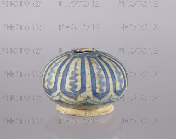 Bottle belly, Abdullazad Mirza Baba fl. ante 1939, Islamic art, Persian, glazed ceramics, utility ceramics, decorated with cicadas, bottle, 18th century, Iran, vessel, height 10.2 cm, diameter 14.1 cm, A rounded ceramic object with a small top opening sits on a short circular base; its surface shows a pattern of vertical curved bands and wavy motifs painted in blue on a pale cream background, with areas of darker blue shading and small spots of discoloration, and the base and rim display a worn, slightly yellowed appearance.