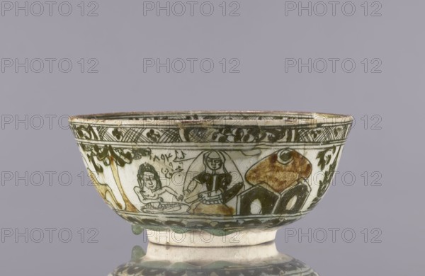 Bowl, late 19th century 1893, Qajar dynasty, Iran; ceramic vessel, height 8.5 cm, diameter 19 cm. Decoration on the rim: Rostam, with a dragon and Majnun i Lejla and the date 1893. Persian/Qajar ceramics; tableware/utility ceramic with figural scenes, dragons, birds, literary motifs; also references to lutes and jambiyah in imagery., A shallow ceramic bowl with a rounded body and short foot, decorated with hand-painted figurative and geometric motifs in green and brown on a pale off-white background; the rim shows a narrow decorative band with crosshatched and floral patterns in green, a central scene around the midsection depicts a group of stylized human figures and abstract shapes outlined in green with areas of brown shading, and leafy vine-like patterns appear near the upper edge; the foot is off-white with traces of green glaze and the surface shows age-related wear and slight chips.