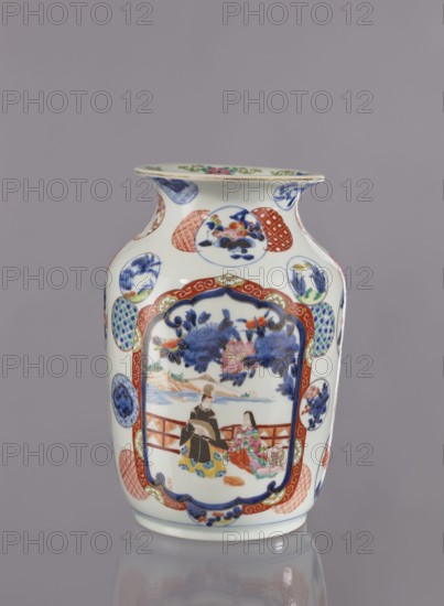 Vase, Japanese, Meiji period 1868–1912, 2nd half of 19th century. Porcelain vessel attributed to Tashiro trading company, Hizen, Arita; height 28.5 cm, diameter 19.0 cm. Colored porcelain with figurative scenes and decorative motifs: peonies, camellias, wisteria, fish, pine trees, asanoha pattern, and genre scenes with landscape background., A porcelain vase with a glossy white background decorated with a group of painted scenes and patterned medallions in colors including blue, red, green, pink, orange, yellow, and black; the main painted panel shows two seated figures wearing garments with black, red, pink, green, and yellow details beneath a floral canopy of blue and pink blossoms, framed by a red and blue ornate border, while the body of the vase is dotted with several circular and oval medallions containing floral and geometric motifs in blue, red, green, and orange; the neck flares outward and carries additional small painted roundels and a decorative rim with green and pink acce...