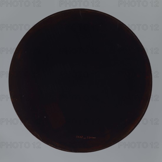 Tray, Meiji 1868–1912, Japanese, early 20th century Meiji Period, kachôga iconography of wisteria, flowers, birds, pines, moon, fans, bridge; vessel, height 2.8 cm, diameter 42.0 cm, A large circular dark object centered against a pale gray background, the circle appearing very dark brown to near black with subtle reddish-brown highlights along its rim and surface, faint scuff marks and scratches visible on the dark area, and a few small lighter specks near the perimeter.