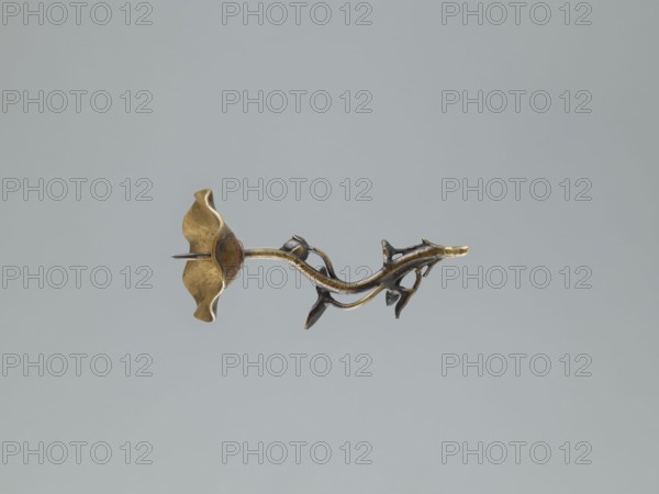 Candlestick shokudai, lotus motifs, turtles and cranes iconography, Japanese, Meiji period 1868–1912, 2nd half of the 19th century, Japan, candlestick, height 37.0 cm, A small metallic object resembling a stylized flower and stem floats against a plain gray background; the piece has a curving stem with branching tendrils and leaf-like forms, and a flared blossom with wavy petal edges. The colors visible are gold, dark bronze, and hints of reddish tones on the blossom, set against a light gray backdrop.