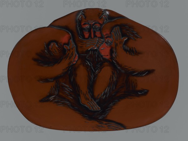 Tray, lacquer, monkeys, sambiki-no saru, Japanese art, trays, Japanese culture, Meiji 1868–1912. Tray in the shape of an irregular oval. Brown, black, and red lacquer decorated using the chôshitsu technique, unsigned. Early 20th century Meiji period, Japan. Vessel; height 2.5 cm, width 27.0 cm, depth 37.0 cm., A rounded, irregularly shaped brown object with a smooth surface sits against a gray background; carved into its center is a dark, stylized depiction of three primate-like figures arranged in a triangular formation with their limbs overlapping, rendered with black engraved lines and darker brown shading, and with reddish highlights on facial areas; the carved fur textures and facial features are emphasized by contrasting black strokes, and the overall palette includes brown, dark brown or black, red, and gray.