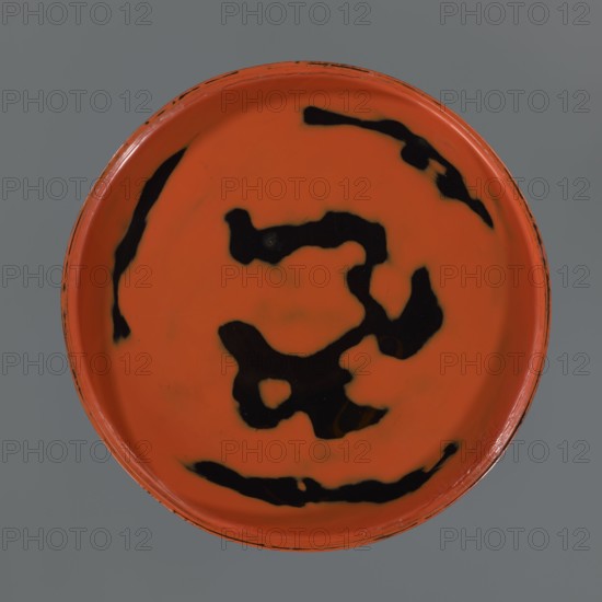 Tray, gift; negoro lacquer; early 20th century Meiji period, 1868–1912; Japan; Japanese art; tray; height 2.5 cm, width 22.7 cm., A round shallow dish viewed from above with a bright orange interior and several irregular black splotches and streaks across its surface, a thin orange rim with slight wear and darker flecks, set against a flat gray background.