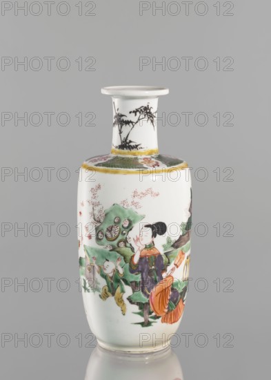 Vase, gift; Chinese; Qing dynasty 1644–1911; 19th century; colored porcelain with figurative scenes images of children and women; narrow-necked vase; vessel; height 26.0 cm, diameter 10.5 cm, weight 1.05 kg., A slender porcelain vase with a narrow neck and flared rim stands against a neutral gray background; the body is primarily white with painted scenes in green, orange, black, yellow, and pink, showing a group of figures in traditional dress amid stylized rocks and foliage, with one figure seated and another childlike figure nearby, and additional decorative motifs around the shoulder and neck including a band with yellow edging and black plant-like silhouettes on the neck.