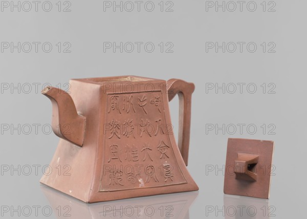 Teapot with a lid; maker, teapot for tea; Yixing-style red-brown stoneware; Chinese; Qing dynasty 1644–1911, 19th century; inscriptions; vessel; height 12.2 cm, width 16.3 cm., A reddish-brown clay teapot with a square, flared base and an angular body is shown with its lid removed and placed beside it; the teapot has a curved spout and a tall, flat handle, with decorative incised marks on one visible side, and the lid is a flat square piece with a raised rectangular knob.