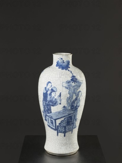Vase, figurative scenes, ceramics, gardens, Chinese art, Chinese culture, blue and white porcelain, games, cracklework decoration, play, Qing dynasty 1644–1911, 18th/19th century Jiaqing period, 1797–1820, China, vessel, height 54.5 cm, width 9.8 cm, A white ceramic vase with a crackled surface glaze stands upright against a dark gray background; it has a rounded body tapering to a narrower neck and a slightly flared rim, and it rests on a dark platform. The vase is decorated with blue painted figures and scenes, including a group of people near a table and a stylized rock formation, all depicted in varying shades of blue. The overall visible colors are white, blue, dark gray, and hints of black around the rim and platform.