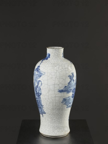 Vase, figurative scenes; ceramics; gardens; Chinese art; Chinese culture; blue-and-white porcelain; games; cracklework decoration; play; Qing dynasty 1644–1911, 18th–19th century—Jiaqing period 1797–1820; China; vessel; height 54.5 cm; width 9.8 cm., A porcelain vase with a crackled white surface and blue painted scenes stands on a dark platform against a plain dark gray background; the vase has a narrow neck and rounded shoulders tapering to a slightly flared base, and shows blue figures and landscape motifs on its sides with visible fine crackle lines across the white glaze, and the overall colors visible are white, blue, dark gray, and a hint of brown around the rim and base.