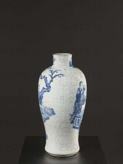 Vase, figurative scenes, ceramics, gardens, Chinese art, Chinese culture, blue-and-white porcelain, games, cracklework decoration, play, Qing dynasty 1644–1911, 18th/19th century Jiaqing period, 1797–1820, China, vessel, height 54.5 cm, width 9.8 cm, An upright ceramic vase with a narrow neck and rounded body sits on a dark pedestal against a dark background; the vase is primarily off-white with a network of fine crackle lines and painted blue decorative scenes, including a tree with branches and a group of human figures in traditional dress, and the rim and base show thin darker edging.