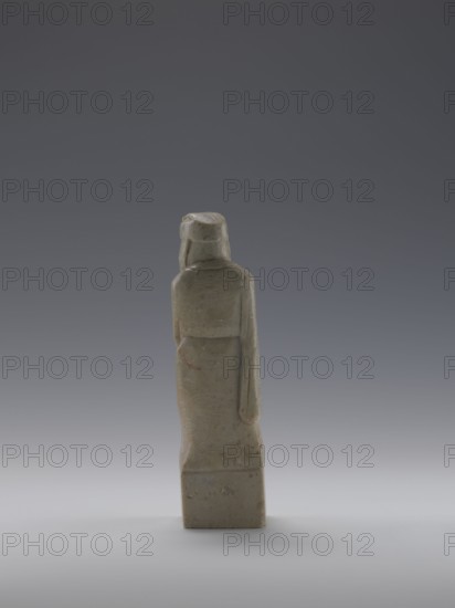 Sage, figurine, men, Chinese art, Chinese culture, Qing 1644–1911, 19th century, China, sculpture, height 16.8 cm, width 4.6 cm, depth 4.3 cm, A single upright sculpture of a human figure viewed from behind, carved from a pale greenish-gray stone with subtle brownish and reddish veins and spots; the figure wears a long robe with a rounded back and a head covering, and one arm hangs down alongside the body while the other is partially visible; the base is a rectangular block of the same stone. Colors visible include pale greenish-gray, gray, brownish-red, and muted beige against a smooth gradient gray background.