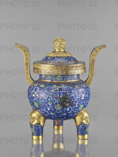 Ding-type incense burner with cover; cloisonné enamel; Qing dynasty 1644–1911, 19th century, China; decorated with bats and dragons, leiwen and meander ornament; vessel; height 38.5 cm, width 34.5 cm., A decorative vessel with a rounded body and a domed lid sits on a reflective surface; the body and lid are covered in intricate enamel patterns dominated by deep blue with accents of turquoise, green, red, white, and gold; two tall, curved handles extend from the sides in a metallic gold with geometric border motifs; the lid has a gold finial with pierced openwork and a scalloped gold rim; the vessel rests on a group of three short legs that are blue with gold floral patterns and topped with sculpted gold animal heads; a broad gold band encircles the rim of the body, and additional gold bands accent the leg ends, creating a contrast with the richly colored enamel decoration.