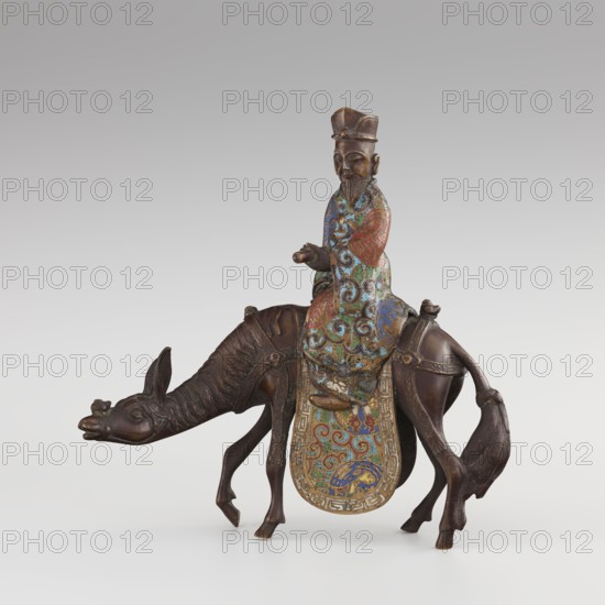 Sage on a Mule, cloisonné enamel, Qing 1644–1911, 19th century, China; sculpture depicting a sage riding a mule with men/figurines, mules, birds and zoomorphic motifs, plant motifs, meander and scroll ornament; height 26.0 cm, width 25.5 cm, depth 6.0 cm., A bronze figure of a bearded man wearing a tall hat sits astride a camel; the man’s robe is decorated with swirling enamel patterns in blue, green, red, and gold, while the camel is dark brown bronze with textured fur details and a long tail; the saddle cloth displays intricate enamel designs in blue, green, red, and gold with a decorative border, and the overall scene is set against a neutral pale gray background.
