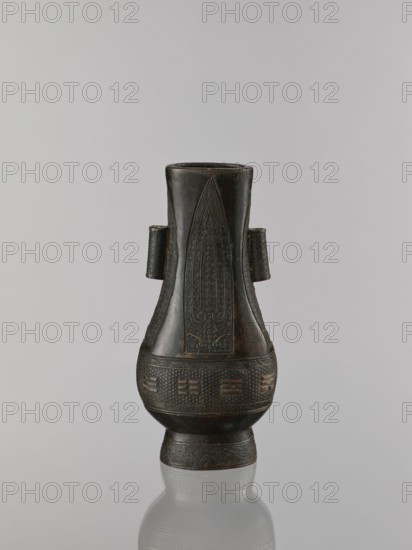 Hu-type vase, ; cicadas; Chinese; hu vessel, vases; Qing 1644–1911; ritual vessel; motifs: waves, asanoha pattern, leiwen ornament, meander ornament; 19th century ; China; vessel; height 22.1 cm, width 10.3 cm, depth 7.5 cm., A dark brown vessel with a narrow neck flaring into a wider body and a rounded base, standing on a short foot and reflected faintly on the glossy surface beneath; the vessel has a pair of small horizontal handles on its upper sides and features carved decorative panels with textured and linear patterns, including elongated triangular motifs and banded ornamentation; the background is a smooth pale gray.