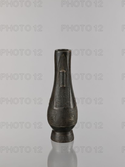 Hu-type vase, cicadas, Chinese, hu vessel, vases, Qing 1644–1911, ritual vessel, waves iconography, asanoha pattern, leiwen ornament, meander ornament, 19th century, China, vessel; height 22.1 cm, width 10.3 cm, depth 7.5 cm., A dark bronze vessel with a tall, elongated neck and a rounded body stands on a short flared base against a pale gray background; the surface of the vessel shows intricate carved geometric and linear patterns concentrated on the midsection and base, and a raised rectangular panel with vertical ridges is visible on the neck, while the overall colors include dark brown, black, and subtle hints of bronze with lighter reflections on the polished areas.