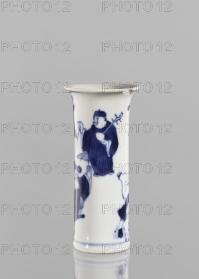 Flute-type vase, gift, figurative scenes, ceramics, Chinese art, blue and white porcelain, Chinese, musicians, stars, 17th century Kangxi period, 1662–1722, Qing dynasty, China, vessel, height 12 cm, diameter 5.6 cm, A tall cylindrical porcelain vessel with a flared rim, glazed in white with blue painted figures and decorative motifs, showing a standing figure holding a long object and wearing flowing garments, additional partial figures and ornamental shapes visible around the body, set against a neutral gray background with a soft reflection below; visible colors include white and blue, with gray in the background.