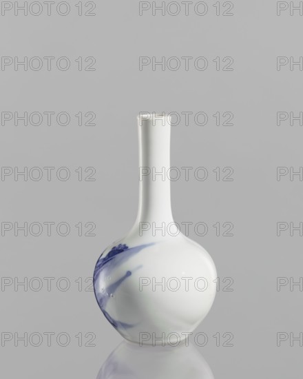 Vase-bottle, blue and white porcelain, Chinese, Kangxi period 1662–1722, figural scenes and landscape motifs, vessel height 12 cm., A smooth ceramic vase with a long narrow neck and round body sits against a plain gray background, primarily white with a few areas of blue brushlike streaks and spots, and a reflective surface showing a faint mirrored image beneath it.