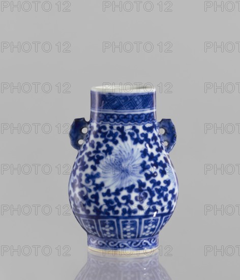 Hu-type vase, ceramics, flowers, hu vessel, blue-and-white porcelain, Chinese art, vase, Chinese culture, lotus tendril ornament, 17th century China, vessel, height 10.5 cm, diameter 4 cm, A small ceramic vase with a bulbous body and a narrow neck, featuring a pair of small looped handles on its sides, all shown against a plain light gray background. The vase is decorated with intricate blue floral and scroll patterns on a white base, with a denser floral motif on the central body and a radiating flower-like design at the front. The neck and foot areas have geometric and banded decorative borders in blue, and the handles are glazed in blue with some white showing through. The colors visible are blue, white, and light gray.