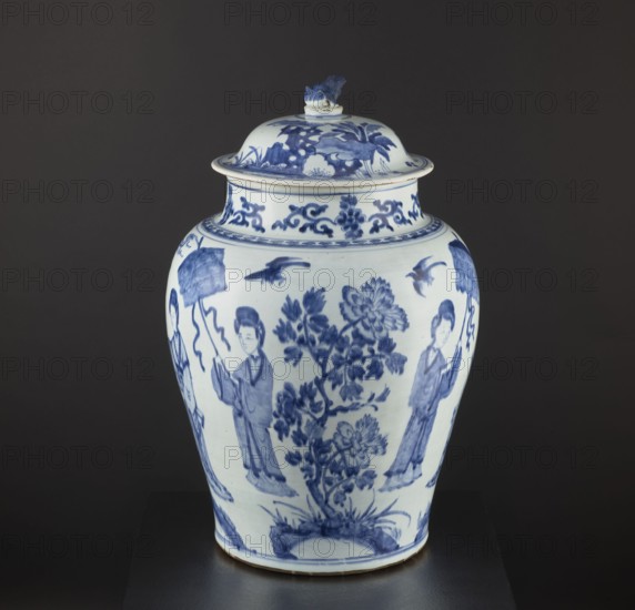 Pot with a cover, Chinese, Qing dynasty 1644–1911, 18th century. Blue-and-white porcelain storage vessel with decorative figurative scenes and images of birds; possibly a Japanese product exported to Europe imitating Chinese wares. Height 58.5 cm; diameter 37 cm., A porcelain jar with a lid sits against a dark background, decorated in blue on a white ground; the jar has a rounded body that tapers toward the base and a domed lid topped with a small sculpted finial. The surface shows blue-painted floral motifs including a central flowering plant with leaves and blossoms, a group of standing human figures in traditional clothing holding objects, a few flying birds, and decorative scrollwork around the neck and rim. The visible colors are blue, white, and dark gray from the backdrop, with subtle off-white tones on the ceramic and faint brown at the base edge.