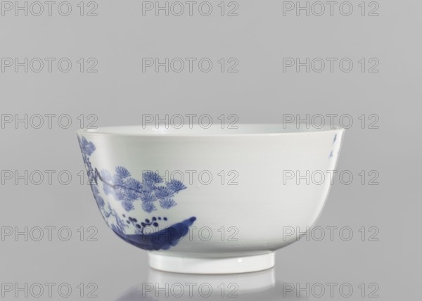 Bowl, ceramics, blue and white porcelain, Chinese, Qing 1644–1911, 19th century, South China; vessel with landscape motifs and fishermen, pines and trees; inscriptions including ?? Wèi Shui, the Wei River, ??? tóu gan rì, the day of casting the fishing rod, ?? Qí Shan, Mount Qi, and ??? rù mèng chén, entering a dream in the morning—a verse evoking a peaceful, nostalgic scene of fishing by the Wei River and Mount Qi; height 8.8 cm, diameter 17 cm., A white ceramic bowl with a short foot rim sits against a pale gray background, showing a blue painted decorative motif along one side that includes leaf-like patterns and brushstroke shapes; the bowl interior is glossy and white, and the visible colors are white, blue, and gray.