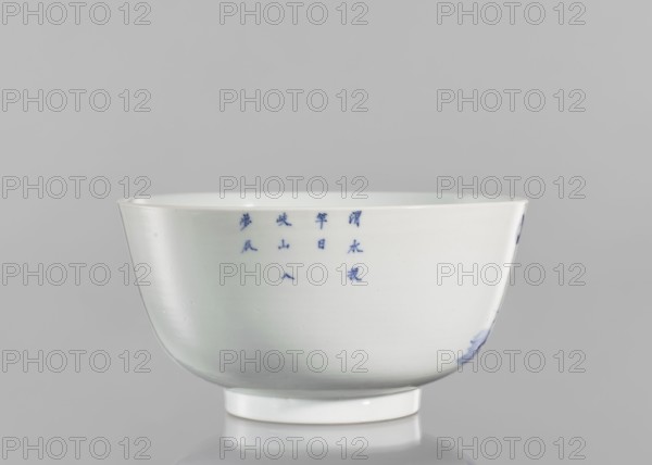 Bowl, ceramics, blue-and-white porcelain, Chinese, Qing 1644–1911, 19th century, South China, vessel, height 8.8 cm, diameter 17 cm. Decorated with landscape motifs: pines, trees, fishermen; inscribed with characters referencing the Wei River ??, Wèi Shui, ??? tóu gan rì, the day of casting the fishing rod, ?? Qí Shan, Mount Qi, and ??? rù mèng chén, entering a dream in the morning, evoking a peaceful, nostalgic scene., A white ceramic bowl with a glossy surface sits against a light gray background, showing a rounded body that tapers to a short circular foot and a gently flared rim; a group of small blue brushstrokes appears on the bowl's side and there is a smudge of blue near the base on one side, with subtle reflections and soft shadows on the surface.