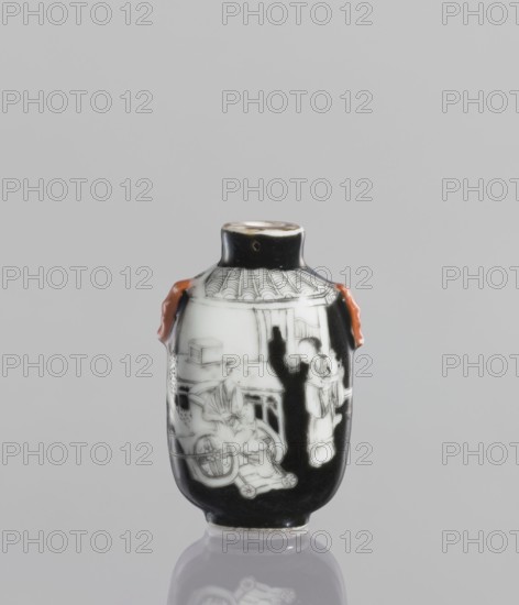 Flask - snuffbox, Chinese, ceramics; flask with figurative genre scenes of horses and riders; ; Qing dynasty Qianlong reign, 18th century, 1736–1795; vessel; height 6.4 cm, A small rounded ceramic snuff bottle with a narrow neck and flared rim, predominantly black with white painted scenes on its body and a glossy finish, featuring a pair of small reddish-orange applied handles on opposite sides; the painted decoration shows figures and architectural elements in white against the black ground, including a seated figure by a wheeled object and a standing figure near a doorway beneath a tiled roof motif, all positioned on a reflective surface that creates a soft mirror image below, set against a plain light gray background.