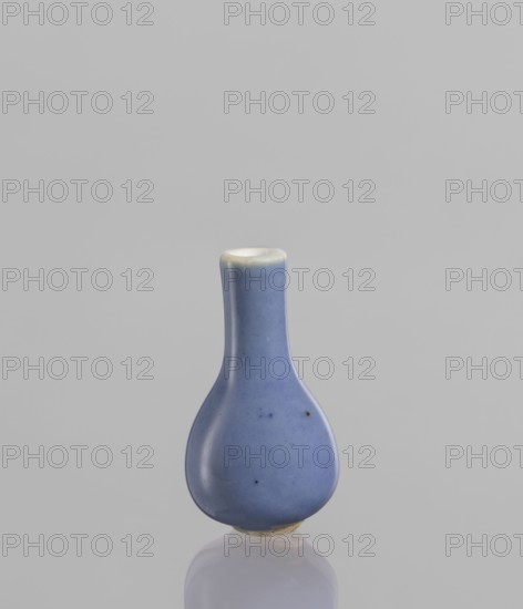 Bottle, gift, Chinese, Chinese art, ceramics, blue and white porcelain, poudre bleu, 19th century, China, vessel, height 5.3 cm, A small pear-shaped ceramic vessel with a narrow neck and rounded body sits centered against a light gray background, the vessel glazed in a smooth blue with a few tiny darker specks and a slightly lighter rim, and its base showing a bit of unglazed beige clay reflected faintly beneath it.