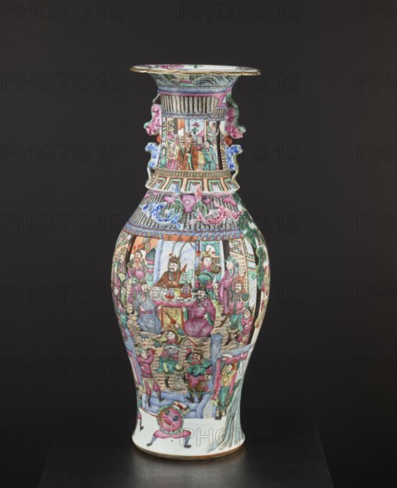Vase, Chinese, colored porcelain, battle scenes, figural scenes, plant ornaments, floral decorations, court scenes, ceramics, decorative vessel, 19th century China, vessel, height 63.2 cm, diameter 21.2 cm, A tall ceramic vase with a narrow neck and flared rim sits against a dark background, decorated all over with detailed painted scenes showing groups of people in traditional clothing, ornate architectural elements, and stylized foliage. The surface features a palette of pink, green, blue, red, orange, white, and gold accents, with several figures clustered around tables, standing on steps, and positioned within framed pavilion-like structures. The neck has applied sculptural elements in pink and blue that resemble stylized animal or floral forms, and the body includes patterned bands and geometric motifs near the shoulder. The base of the vase is white with painted figures and decorative elements, and the overall finish is glossy porcelain.