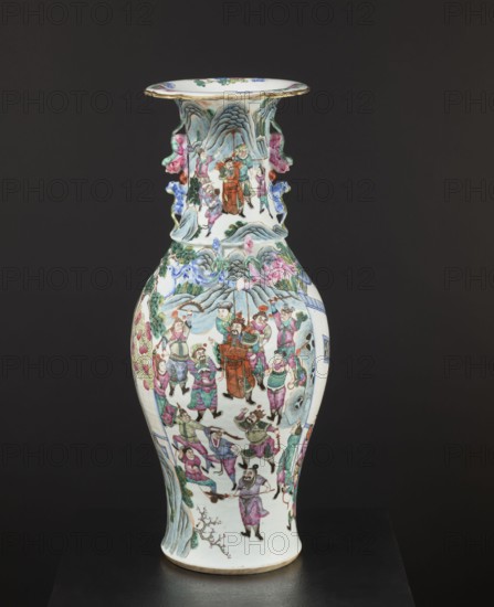 Vase, Chinese, 19th century, colored porcelain; decorated with battle scenes, figural scenes, court scenes, plant ornaments and floral decorations; vessel, height 63.2 cm, diameter 21.2 cm., A tall porcelain vase with a flared rim sits against a dark background, decorated all over with painted human figures in various poses and garments on a white base. The vase features a group of small sculpted handles or applied decorative elements on its neck, painted in shades of pink, blue, and green. The painted scenes include people wearing robes and tunics in colors such as red, pink, green, purple, and blue, with accenting details in black and brown. The background of the painted imagery includes stylized mountains and clouds rendered in muted blues and greens, along with areas of pale gray. Floral and foliage motifs appear in green and pink near the lower and middle sections. The rim has a thin band of gold or gilt around its edge, and the base shows a natural ceramic color. The overall pale...