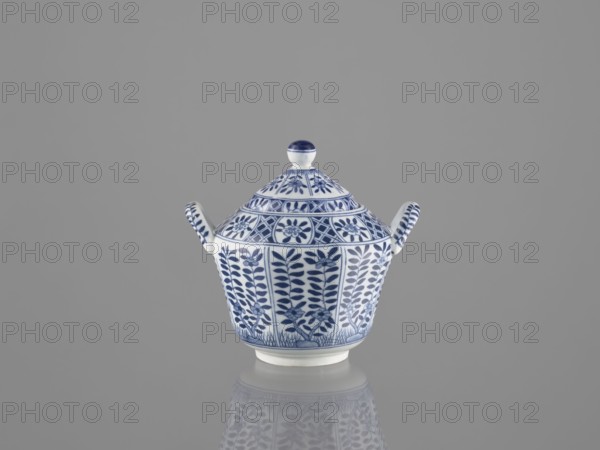 Sugar bowl with lid, ceramics, sugar bowl, Chinese art, Chinese culture, lid, 20th century, China, vessel, height 12 cm, A small lidded porcelain vessel with two short handles sits centered against a plain gray background, its surface decorated in blue floral and geometric patterns on a white base, and its reflection visible on the glossy surface below; colors visible include blue, white, and gray.