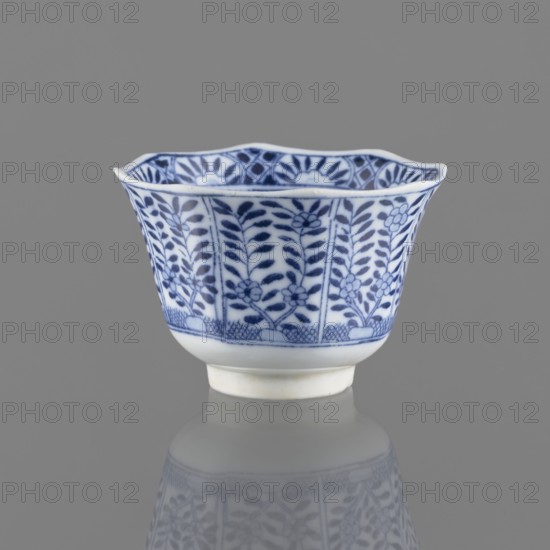 Bowl, Chinese, Chinese art, ceramics, 20th century, China, vessel, height 5.3 cm, diameter 7.8 cm, A small porcelain cup with a flared, scalloped rim sits against a gray background, decorated in blue and white with a repeating floral and leafy pattern on its exterior and a narrow foot at the base, the surface showing a soft reflection beneath it; visible colors include white, blue, gray, and a hint of off-white on the foot.