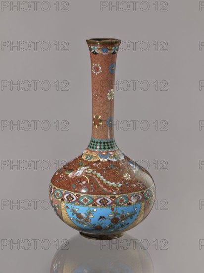 Vase, Japanese, Meiji period ca. 1880, Meiji 13, cloisonné enamel vessel, height 30.5 cm, diameter 16.0 cm; decorated with plants, butterflies, phoenixes hoo/kinseki., A tall, slender-necked vase with a bulbous base sits against a plain gray background; the vase surface shows a reddish-brown ground with ornate floral and bird motifs in colors including turquoise blue, light blue, white, green, gold, and touches of black and red, with a band of bright sky-blue panels around the lower body decorated with floral designs, decorative scalloped and geometric patterns in turquoise and gold near the neck, and several flower motifs and small detailed swirls on the neck and shoulder, all reflected faintly on the glossy surface below.
