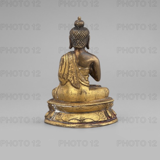 Shakyamuni Buddha, Buddha iconography, Himalayan/Tibetan Buddhist art, Buddha ca. 560–480 BCE, ushnisha, 19th century, Tibet, sculpture figurine, height 6.7 cm, width 3.3 cm, depth 4.1 cm, A small gilded statue of a seated figure shown from the back, with a textured bun on the head and detailed carved hair, wearing a draped garment with ornate patterned folds, seated on a rounded decorated pedestal; visible colors include gold on the statue and pedestal, darker bronze or brown on the upper back and hair, and a pale gray background.