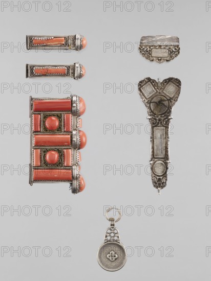 Braid ornament, braid ornament jewelry, braid ornaments, women's ornament, Mongolian, 19th–20th century, materials: jewelry; height 3.0 cm, width 7.8 cm, A vertical arrangement of several metal and stone objects on a pale gray background includes a rectangular decorative piece with coral-colored cylindrical and round stones set in an ornate silver frame, a pair of narrow silver bars each with coral-colored insets, an elongated ornate silver element with an open top section and engraved patterns, a small scalloped silver plate, and a round silver pendant with a patterned border and a linked loop; visible colors include coral, silver, gray, and a hint of brass-toned metal.