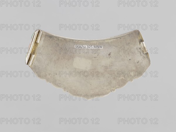 Braid clasp, purchase provenance; clasps, braid ornaments, jewelry, artistic crafts; Mongolian women's ornament, 18th–19th century, Mongolia; dimensions: length 9.3 cm, width 4.5 cm, thickness 0.7 cm, height 0.7 cm., A curved, scalloped metal object with a worn, slightly tarnished silver-gray surface and areas of darker discoloration, showing a hinge-like element on each end with small patches of goldish and greenish tones, set against a plain light gray background.