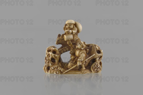 Netsuke in the shape of Daikoku and Ebisu, Ryôji fl. ca. 1886–1900? sculptor; author unknown. Japanese, Meiji period 1868–1912. Carved miniature netsuke katabori depicting Daikoku and Ebisu from the Seven Gods of Good Fortune: Daikoku sits on a rat holding a hammer in his left hand with a bag on his back; Ebisu holds a fishing rod and rides a giant fish. Finely carved in a miniature rocky landscape with a bridge, showing detailed facial features, fish scales, bamboo leaves on openwork rocks, rat fur, and rat’s eyes set with microscopic black-dyed bone inlays. 4th quarter of the 19th century, Japan. Height 3.9 cm; width 4.0 cm., A small carved ivory-colored figurine depicts a scene with a few humanlike figures and an animal on an ornately textured base; the carving shows a standing figure holding a long pole and wearing patterned clothing, a second seated figure above holding a rounded object, and an animal with pointed ears nestled between them, all carved with detailed patterns, scale...