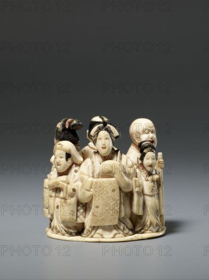 Okimono in the shape of a group of six singing people; maker, Japanese, Meiji period late 19th century; figurines/okimono carved as musicians depicting a courtesan with a small kamuro servant, a townswoman carrying a lantern, a wealthy merchant with a fan, a messenger with an oblong box, and a blind Buddhist monk with a shaved head leaning on a cane; sculpture; height 5.1 cm, width 5.2 cm, depth 4.5 cm., A group of small carved figures made of a creamy off-white material with darker incised details arranged on a rounded base, showing a central figure wearing a patterned robe and ornate headdress flanked by several other figures with varied headwear and facial expressions, some holding objects and one with a staff; the carving displays fine etched patterns and hair details highlighted in dark tones, and the visible colors are creamy off-white, black, and hints of brown against a neutral gray background.
