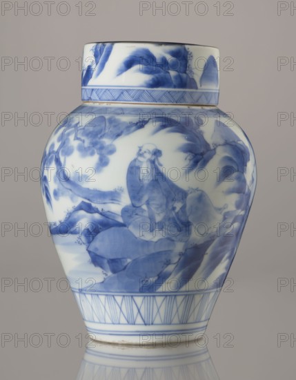 Storage vessel with lid by Zôshuntei Sanpo c. 1842–1878. Pear-shaped blue-and-white porcelain storage pot with flat cylindrical lid, Arita, Japan; height 21.8 cm, diameter 15.3 cm. Decorated in a Chinese-style landscape: an old man resting under a pine on a rocky cliff overlooking a broad body of water, with mountainous scenery, a waterfall, lofty peaks, and distant boat sails. Lower base features a wide ornamental band of three vertical and two crossed lines; neck and lower edge of lid have diagonal-line bands forming triangular motifs; lid decorated with a rock motif. Style modeled on Chinese Southern School painting and Japanese bunjinga nanga influence; free-form painting with precise, masterful cobalt underglaze lines in bright, pure tones. Underglaze signature: Zoshuntei Sampo zo made by Zoshuntei Sampo. Materials: blue-and-white porcelain. Period: late Edo–Meiji., A ceramic jar with a lid, predominantly white with blue painted designs, showing a landscape scene with a seated hum...