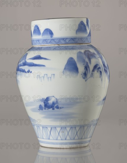 Storage vessel with lid by Zôshuntei Sanpo Zoshuntei Sampo zo, c. 1842–1878. Blue-and-white porcelain, Arita, Japan. Pear-shaped vessel with a flat cylindrical lid; height 21.8 cm, diameter 15.3 cm. Decorated in a Chinese-style landscape: an old man resting alone under a pine tree on a rocky cliff overlooking a vast body of water, contemplating a mountainous scene with a waterfall, lofty peaks, and distant boat sails. Lower base features a wide ornamental band of three vertical and two crossed lines; neck and lower edge of lid have diagonal-line bands forming triangular motifs; lid decorated with a rock motif. Decoration modeled on Chinese Southern School painting and influenced Japanese bunjinga nanga style. Free-form painting with precise, masterful lines; cobalt in bright, pure shades in several tones. Underglaze cobalt signature on the base: Zoshuntei Sampo zo. Edo–Meiji period, Japan., A ceramic jar with a rounded body and a short cylindrical neck, decorated in blue on a white gro...