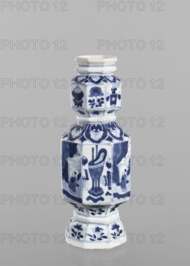 Vase, figurative scenes, ceramics, Chinese art, blue and white porcelain, floral decorations, Qing 1644-1911, decoration with repeating figurative scenes, flower vases and flowers, 18th century, China, vessel, height 13.4 cm, diameter 8.8 cm, A blue-and-white ceramic vessel with a multi-tiered, hexagonal shape sits against a plain gray background; the object displays a glossy white base color with deep blue painted decorative motifs including floral patterns and abstract shapes on each faceted panel, a narrower neck with banded ridges, a wider midsection with stylized figures and ornamental designs, and a flared pedestal base that also features blue floral decorations.