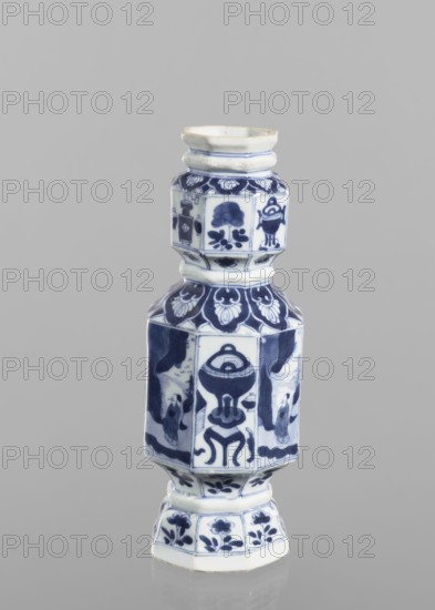 Vase, figurative scenes, ceramics, Chinese art, blue-and-white porcelain, floral decorations, Qing 1644–1911, decoration with repeating figurative scenes, flower vases and flowers, 18th century, China, vessel, height 13.4 cm, diameter 8.8 cm, A tall ceramic vessel with an angular, tiered shape standing against a plain light gray background, decorated in blue and white with painted floral motifs and abstract decorative panels; the piece has a narrow flared rim, a segmented neck and body with hexagonal facets, a wider midsection, and a stepped base, all showing blue-painted patterns and stylized flower and leaf designs on a white ground.