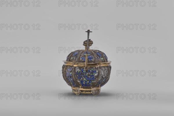 Basket with a lid; maker, Chinese; 19th century, Canton, China; container decorated with flowers and ornaments; height 9.8 cm, width 10.5 cm, depth 7.5 cm., An ornate rounded container with a domed lid and a handle, primarily metallic gold and dark silver in color, decorated with blue and green enamel floral motifs and intricate engraved patterns; the lid has repeated ribbed sections with floral enamel insets and a central finial topped by a small cross-like element, while the body rests on a few short feet and features matching floral enamel panels and gilt bands around the rim and base, set against a plain light gray background.