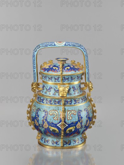 You-type vessel with a lid on a stand; Chinese, Qing dynasty, Qianlong period 1736–1795. Cloisonné enamel cellular enamel ritual/ceremonial you vessel originally used for storing alcoholic beverages form originates in the Shang Dynasty. Elaborate, precise, multi-colored cloisonné decoration on body and lid depicting a taotie mask and stylized bird images, motifs borrowed from archaic bronzes; plastic insets on the sides and animal heads on both sides of the movable handle. Wooden base mattly polished rosewood of elongated shape, decorated with bas-relief symbolic representations bats and spiral ornament. Materials/technique: cloisonné enamel, wood stand. Dimensions: vessel height 39.0 cm, width 24.0 cm, depth 19.0 cm, weight 5.6 kg; stand height 55.0 cm, width 30.0 cm, depth 18.0 cm, weight 1.8 kg., The image shows a decorative vessel with a rounded body, a fitted lid, and an arched handle, featuring a dominant palette of blue and gold with accents of light blue, dark blue, red, green,...