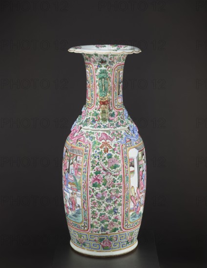 Vase, Chinese, Qing dynasty 1644–1911, colored porcelain, ceramics; subject: lizards, lion iconography, figurative and genre scenes, plant motifs with fruit in the background; decorative vessel/vase; 2nd half of the 19th century; China; height 90 cm, diameter 37.5 cm., A tall porcelain vase with a flared rim and a long neck sits against a dark background; the vase is predominantly white and decorated with a dense pattern of pink and green floral motifs, green leaves, and small birds, with additional colors including blue, yellow, and touches of red and purple; the neck features raised green and gold ornamental handles and panels outlined in pink and yellow, while the body displays alternating vertical panels with intricate scenes and floral fields framed by multicolored borders; a band of geometric patterns in blue and yellow encircles the base, and the rim interior shows scattered floral decoration in pink and green.