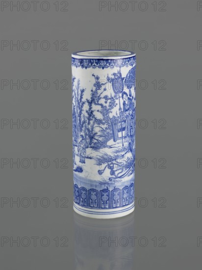 Vessel, Narozno Eckersdorf, Japanese art, Japanese, ceramics, figurative scenes, female images, decorative vessel, restitution provenance, 19th century, Japan, vessel, height 39.3 cm, diameter 15.5 cm, A cylindrical ceramic vase standing upright on a reflective surface, predominantly white with detailed blue painted decoration; the blue designs include a band of patterned motifs near the top rim, a scenic narrative with human figures, trees, and architectural elements around the body, and a repeating decorative border near the base; the background surface is a uniform gray and the vase casts a subtle reflection below.