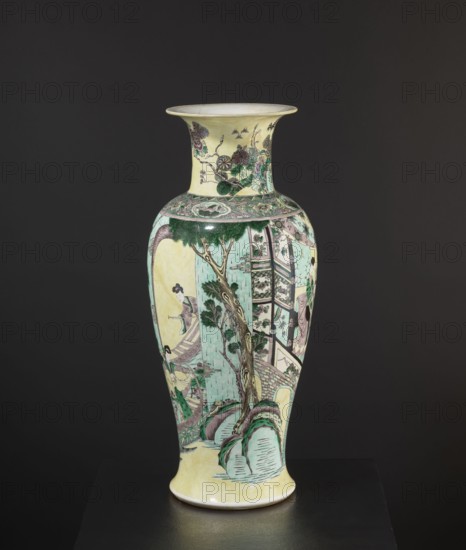 Vase, park scenes with architecture, enamel paints, Chinese art, Chinese culture, ceramics, decorative vessel, colored porcelain, 19th century, China, vessel, height 59.5 cm, diameter 25.5 cm, A tall ceramic vase with a flared rim and a rounded body stands against a dark background, decorated with painted scenes and motifs in pale yellow, mint green, dark green, soft pink, muted purple, brown, black, and cream; the neck shows floral and foliate designs while the body features a landscape with a tree, rocky formations, architectural elements, and a group of figures wearing flowing garments, all outlined and shaded in fine lines and washes of the mentioned colors.