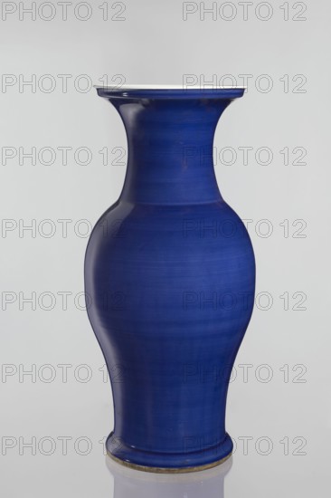 Vase, Chinese, decorative vessel, Qing style Qing dynasty, 1644–1911, ceramic, 19th century, China; vessel; height 62.5 cm, diameter 28.5 cm, A smooth vase with a curving silhouette in a deep cobalt blue finish, displaying subtle horizontal banding and variations in tone, with a slightly flared rim that has a thin lighter edge and a rounded base that sits on a narrow foot ring showing a muted metallic accent; the background is a soft pale gray.